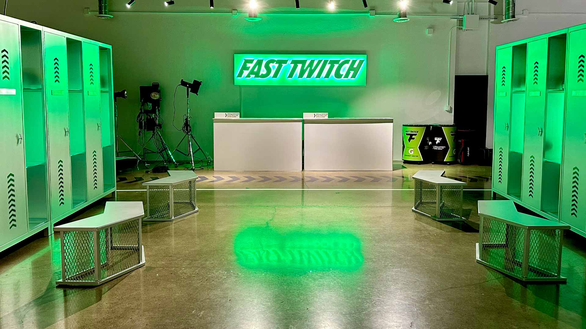 Locker room bathed in green light with Fast Twitch sign.