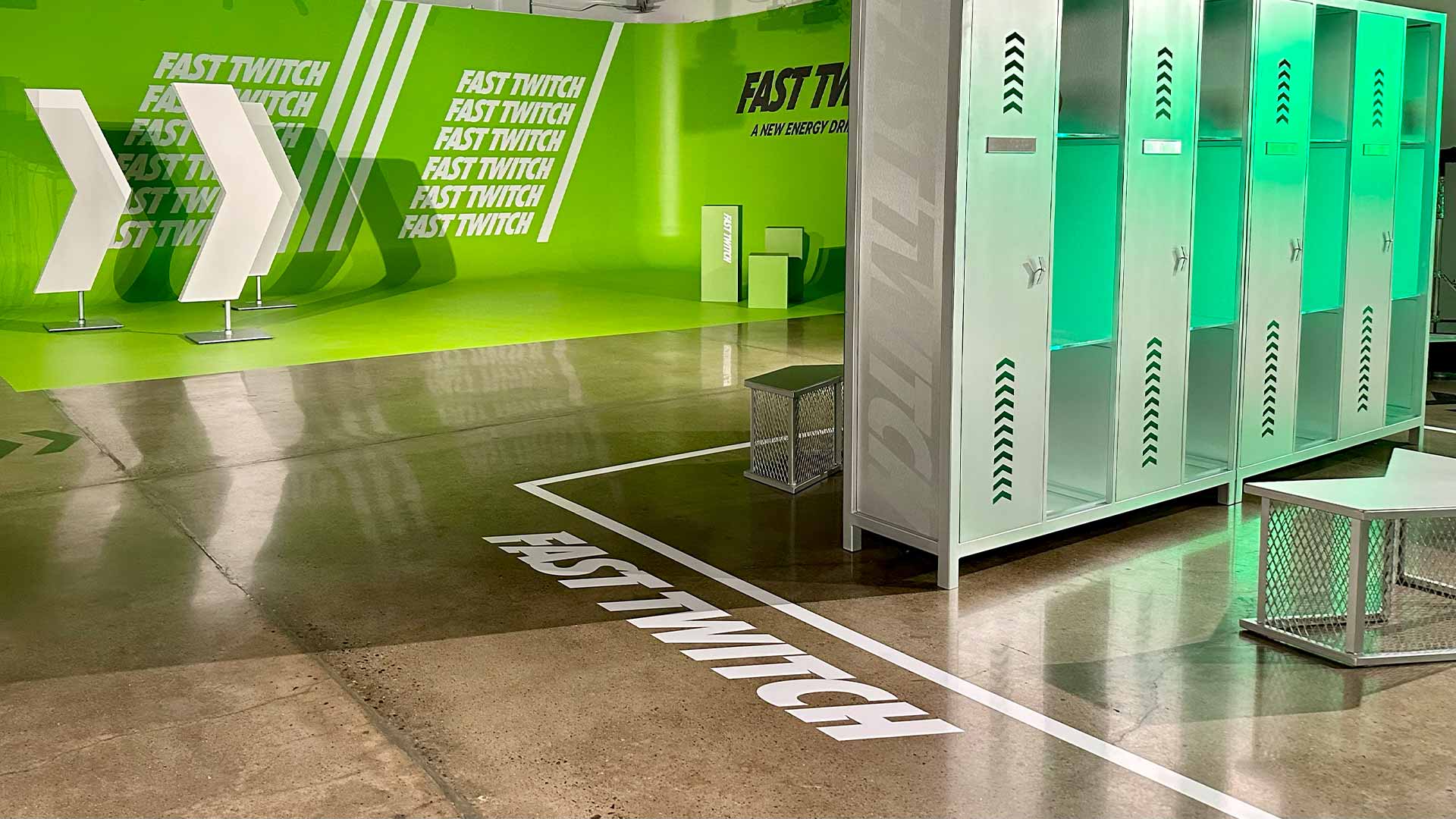 Fast Twitch locker room with custom graphics and green lighting.